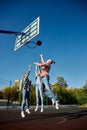 Group of friends bonding outdoors to play street basketball. Teens wearing casual style clothes. Kids look happy Royalty Free Stock Photo