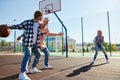 Group of friends bonding outdoors to play street basketball. Teens wearing casual style clothes. Kids look happy Royalty Free Stock Photo