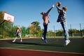 Group of friends bonding outdoors to play street basketball. Teens wearing casual style clothes. Kids look happy Royalty Free Stock Photo