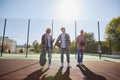 Group of friends bonding outdoors to play street basketball. Teens wearing casual style clothes. Kids look happy Royalty Free Stock Photo