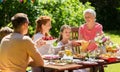 Happy family having dinner or summer garden party