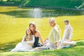 Leisure, holidays and people concept - happy female family having festive dinner or summer garden party Royalty Free Stock Photo