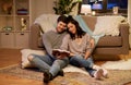 Happy couple reading book at home Royalty Free Stock Photo