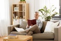 Man sitting on sofa and reading book at home Royalty Free Stock Photo