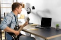 Young man with laptop playing guitar at home Royalty Free Stock Photo