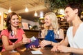 Women paying bill at wine bar or restaurant Royalty Free Stock Photo