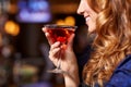 smiling woman drinking cocktail at night club Royalty Free Stock Photo