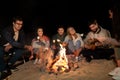 Friends roasting marshmallow on camp fire on beach Royalty Free Stock Photo