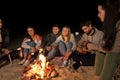 Friends roasting marshmallow on camp fire on beach Royalty Free Stock Photo