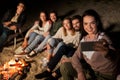 Happy friends taking selfie at camp fire on beach Royalty Free Stock Photo