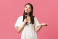 Leisure, people emotions and lifestyle concept. Charismatic pretty young asian girl making jokes, performing stand-up or