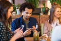 Friends with smartphones eating at restaurant Royalty Free Stock Photo