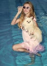 Leisure at sea. Girl with small dog in swimming pool Royalty Free Stock Photo