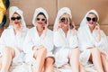 Leisure spa women relaxation bathrobes smartphones