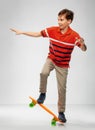 Smiling boy riding on short skateboard Royalty Free Stock Photo
