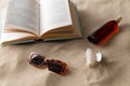 book, sunglasses and sunscreen on beach sand Royalty Free Stock Photo