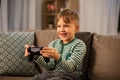 Little boy with gamepad playing video game at home Royalty Free Stock Photo