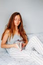 Leisure time activity. Young woman reading in bed Royalty Free Stock Photo