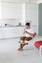 Man sitting in a chair watching tv holding remote control Royalty Free Stock Photo