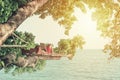 Leisure on the tree and sea. Happy and beautiful asian woman lying in the hammock, is reading book and enjoy her vacation.process Royalty Free Stock Photo