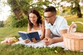 happy couple reading book on picnic at summer park Royalty Free Stock Photo