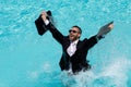 Leisure weekend and remote freelance work. Crazy comic business. Funny businessman in suit with laptop in swimming pool