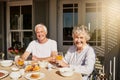 Leisurely breakfast with my beloved. a happy senior couple having a leisurely breakfast on the patio at home. Royalty Free Stock Photo