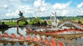 Lembuswana Statue surrounded with dragon figure in the pond with beautiful sky in Pulau Kumala, Indonesia