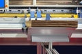 lements of corton boxes are collected in stack. Conveyor line for the production of boxes. Machine cuts cardboard boxes from sheet Royalty Free Stock Photo