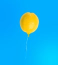 Lemon balloon isolated on blue background