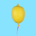 Lemon balloon on light blue background