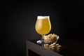 Lemon beer and bowl of peanuts Royalty Free Stock Photo