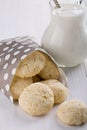Lemon biscuits in a paper bag and a jug of milk Royalty Free Stock Photo