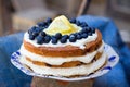 Lemon blueberry naked cake with blueberries on the top and mascarpone butter frosting Royalty Free Stock Photo