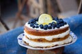 Lemon blueberry naked cake with blueberries on the top and mascarpone butter frosting Royalty Free Stock Photo