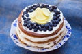 Lemon blueberry naked cake with blueberries on the top and mascarpone butter frosting Royalty Free Stock Photo