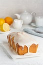 Lemon bread coated with sugar sweet. Cake with citrus, Whole loaf, side view, close up, vertical