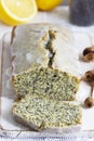 Lemon cake with poppy seeds, covered with glaze on a light background.