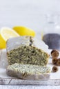 Lemon cake with poppy seeds, covered with glaze on a light background.