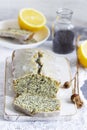 Lemon cake with poppy seeds, covered with glaze on a light background.