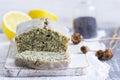 Lemon cake with poppy seeds, covered with glaze on a light background
