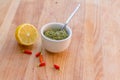 Lemon, chilli pepper and source on wooden cutting board, cooking