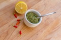 Lemon, chilli pepper and source on wooden cutting board, cooking