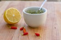 Lemon, chilli pepper and source on wooden cutting board, cooking