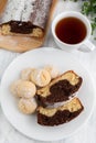 Lemon chocolate cupcake and cookies in a plate, a cup of tea on a light table Royalty Free Stock Photo