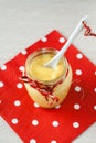 Lemon cream in a glass jar stands on a napkin