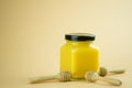 Lemon curd in a glass jar. Nearby with honey dipper stick Royalty Free Stock Photo