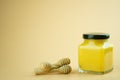 Lemon curd in a glass jar. Nearby with honey dipper stick Royalty Free Stock Photo
