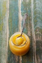 Lemon curd in glass jar on rustic wooden table, traditional fruit cream