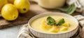 Lemon custard pie in a white dish, topped with fresh lemon slices and mint, rustic setting